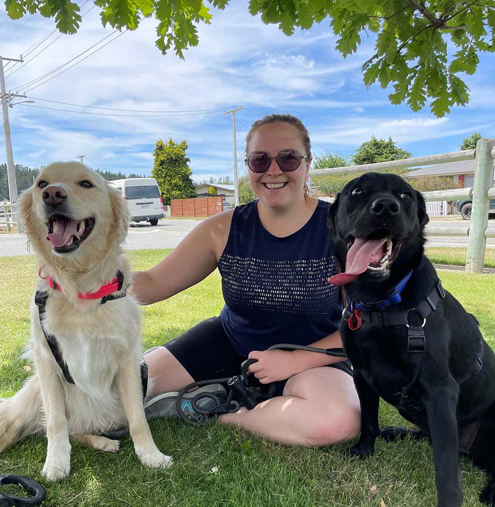 Bradi - owner and audiologist at Bishopdale Hearing - with her dogs